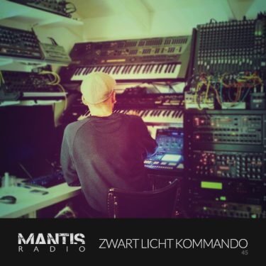 Zwart Licht Kommando sat in front of banks electronic drum machines and synths
