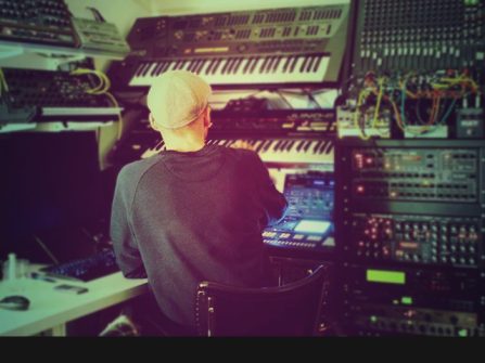 Zwart Licht Kommando sat in front of banks electronic drum machines and synths