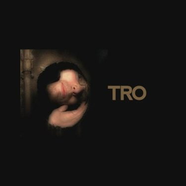 TRO looking through a hole at an angle, with the text of his artist name on the right to his head