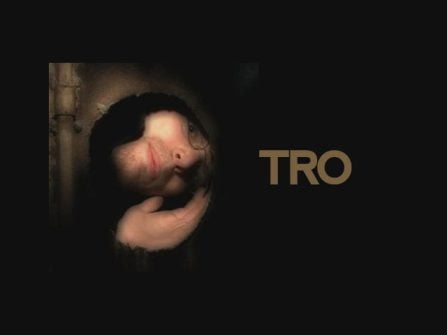 TRO looking through a hole at an angle, with the text of his artist name on the right to his head