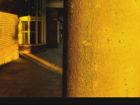Yellow sunlit concrete corridor and doorway - sclist Mantis Radio flyer