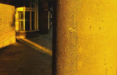 Yellow sunlit concrete corridor and doorway - sclist Mantis Radio flyer