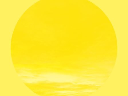 Yellow background with a circle taking up most the area, with a yellow overlaid sky.