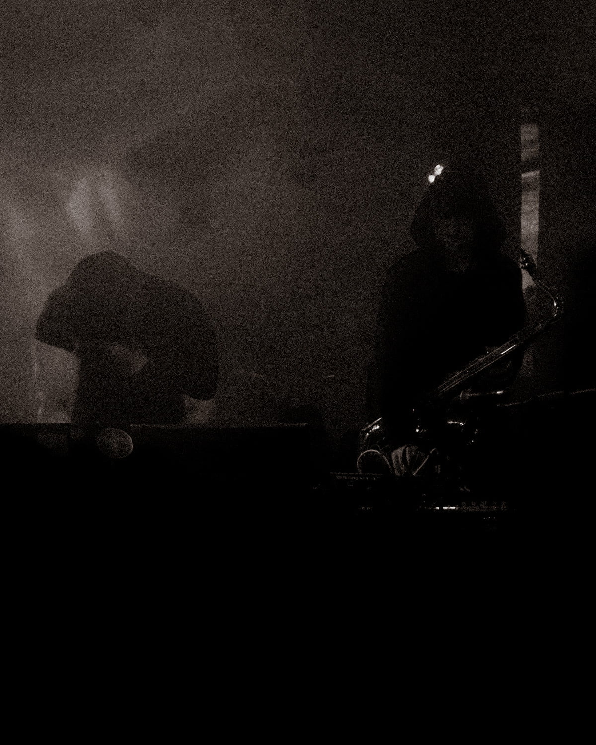 dark shadowy photo taken of A Vengeance performing in Scotland.